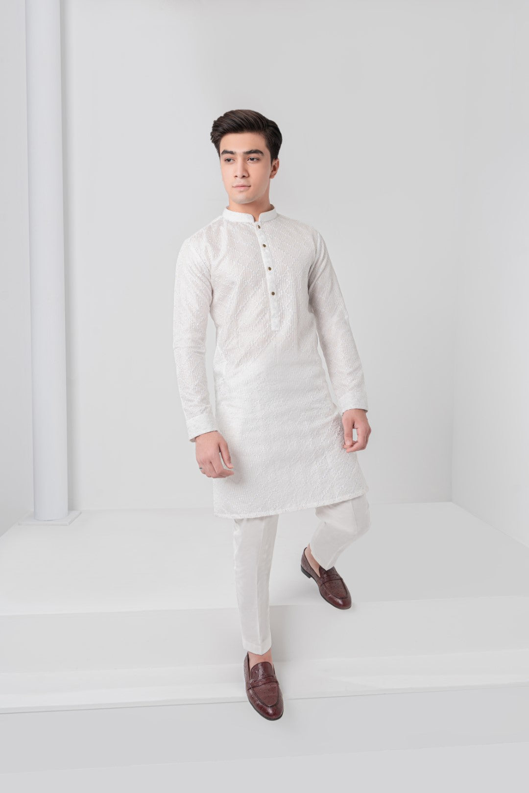 white cross design embroidered kurta and plain trouser.